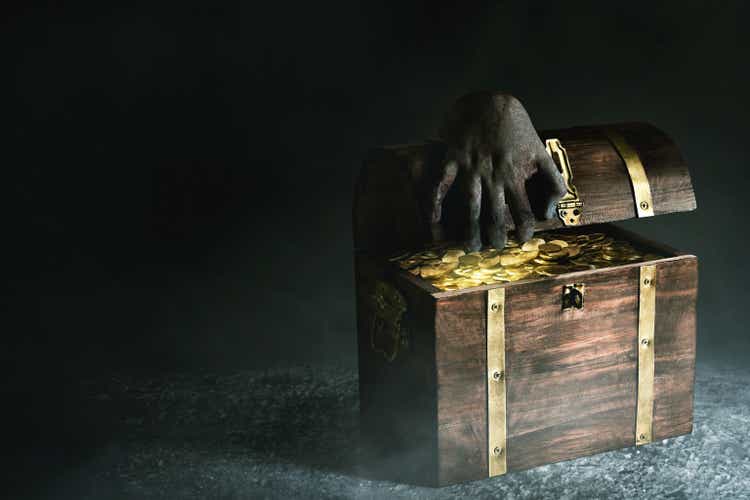 Scary hand opening wooden treasure chest