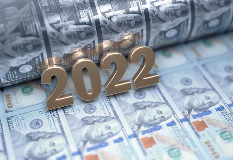 Gold Colored 2022 Sitting Over American Dollar Bills - Money Printing and Inflation Concept