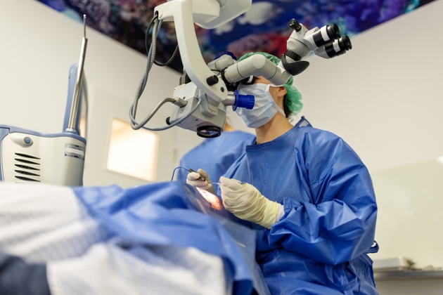 Doctor performing an eye surgery under the microscope at the hospital