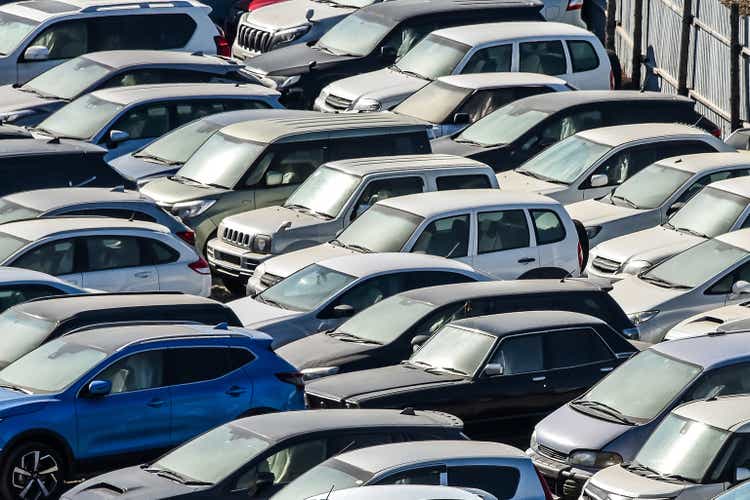 Many cars parked and distributed in rows