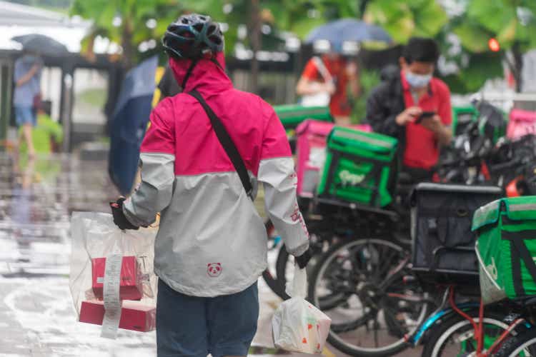 Food delivery workers working on a rainy day in Singapore