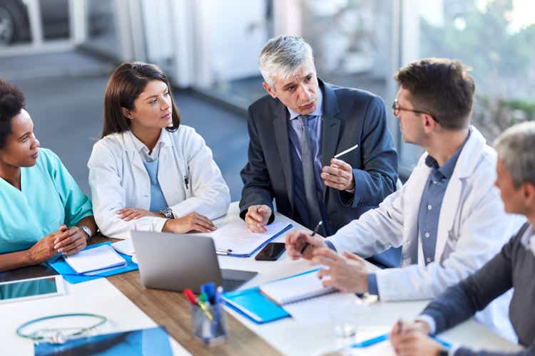 Doctors having a meeting with administrator in a hospital.