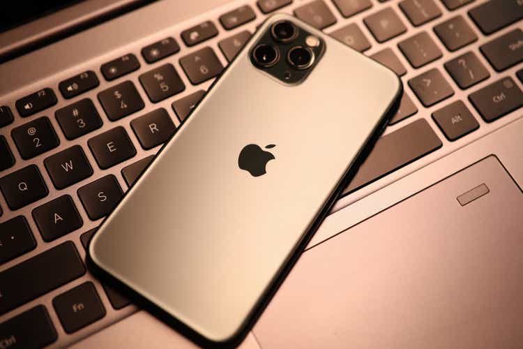 New model apple iphone lies on laptop keyboard closeup