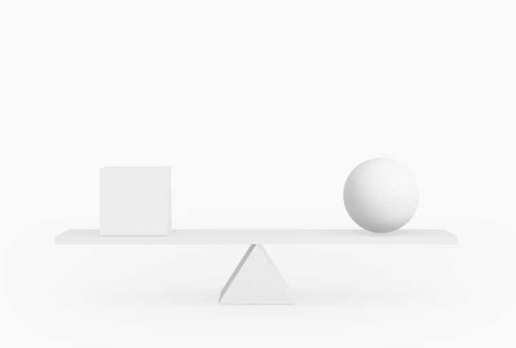 Round shape and square shape balancing on plank board isolated on white.