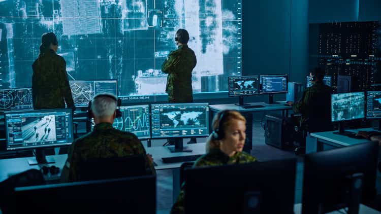 Military Surveillance Team of Officers Locked a Target on a Vehicle from a Satellite and Monitor it on a Big Display in Office for Cyber Operations for Managing Security and Army Communications.