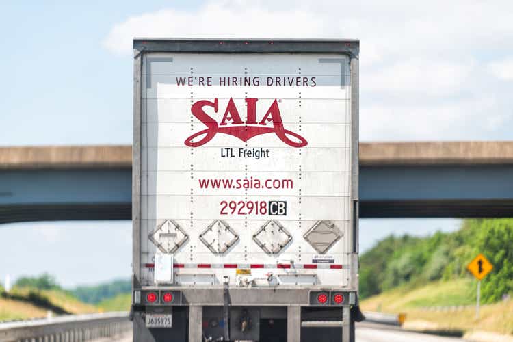 Highway interstate road in Virginia with truck vehicle for Saia transport and sign for hiring drivers application on online website