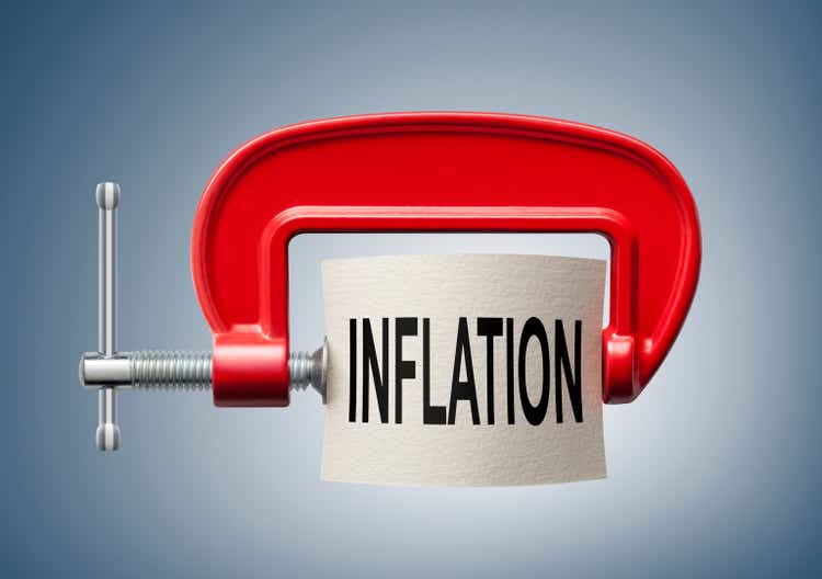 Inflation. The word "inflation" is compressed with a c-clamp.
