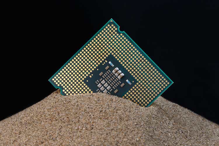 Microprocessor and sand on black background