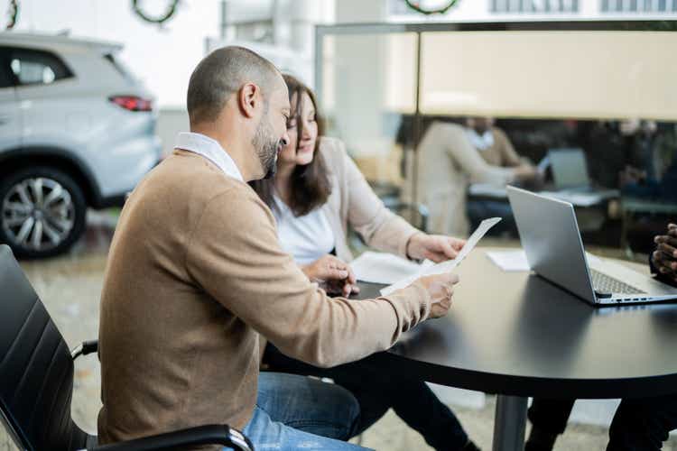 Mature couple talking and deciding to buy a new car