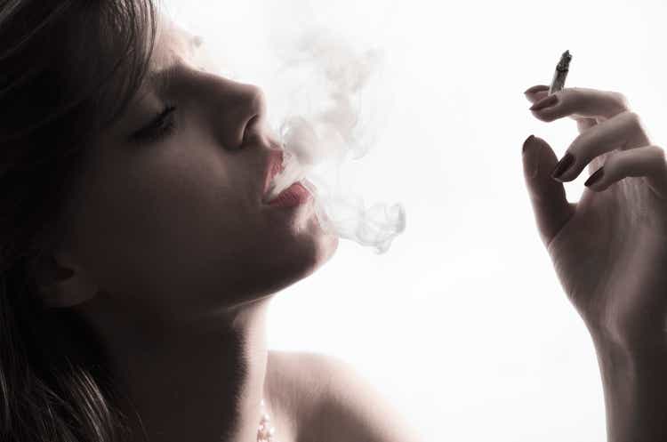Woman smoking cigarette. Closeup
