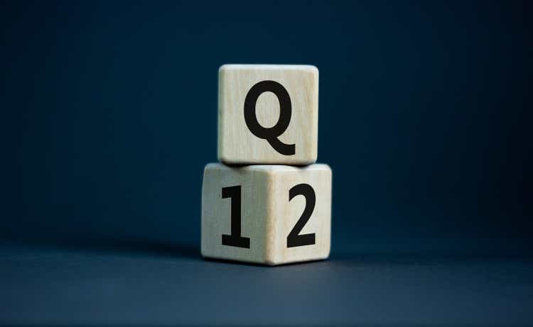 From 1st to 2nd quarter symbol. Turned wooden cubes and changed words "Q1" to "Q2". Beautiful grey table, grey background. Business, happy 2nd quarter Q2 concept, copy space.