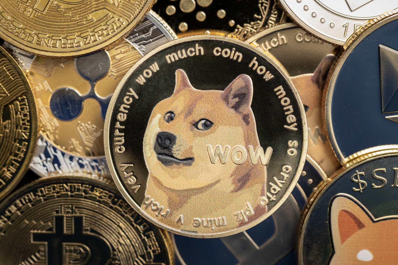 Dogecoin cryptocurrency coin close-up, on top of other cryptocurrency coins