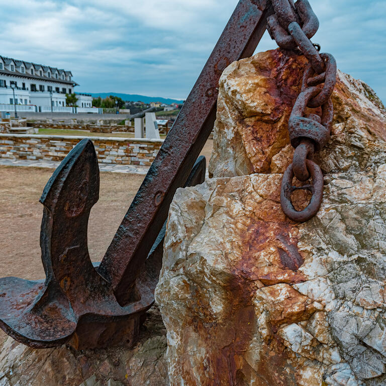 Rusty anchor with chain foreground