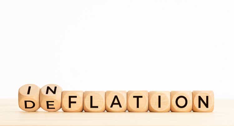Inflation or deflation word in wooden blocks on table