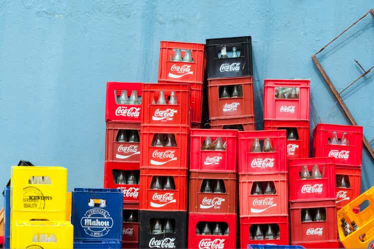 Heap of multicolored plastic crates outside a bar.