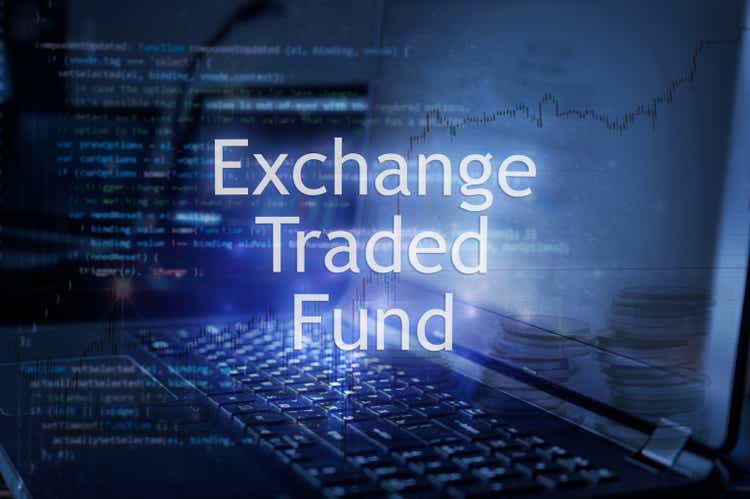 Exchange traded fund inscription against laptop and code background