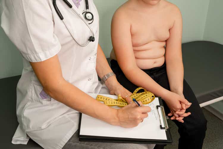 Childhood obesity problem. Fat boy at a nutritionist appointment.