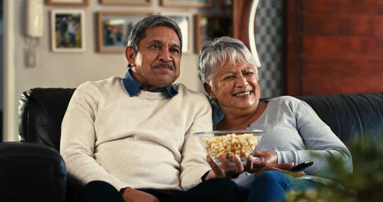 Shot of a senior couple watching tv on the sofa at home