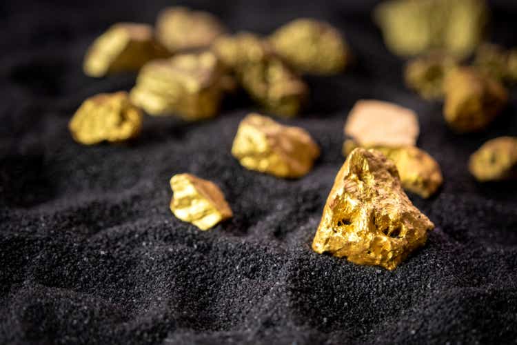 Pure gold from the mine that was unearthed was placed on the black sand.