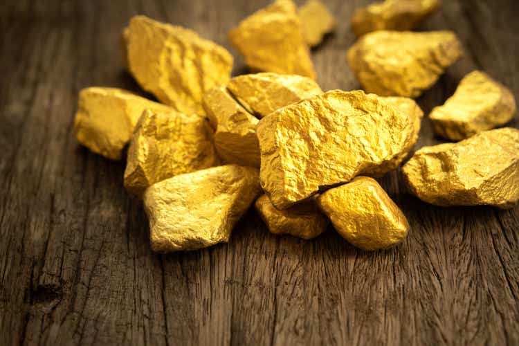 Pure gold ore on old wooden floor