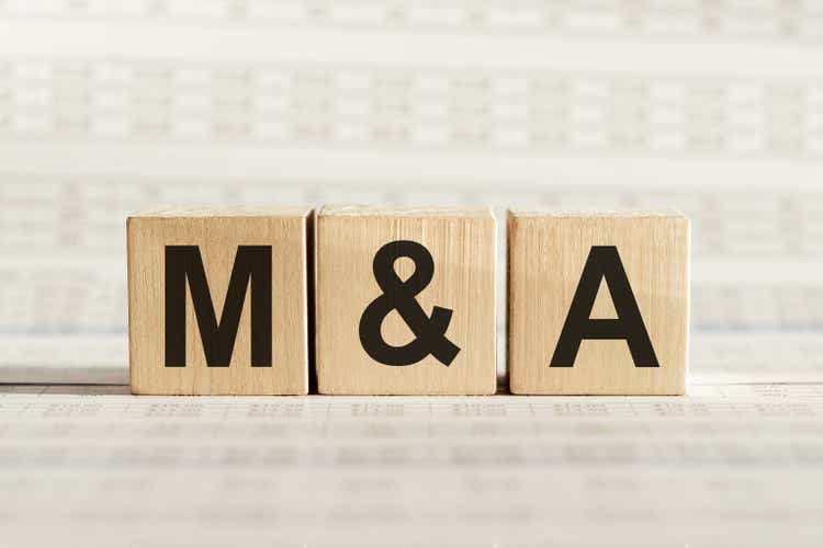 M&A abbreviation - mergers and acquisitions, on wooden cubes on a light background.