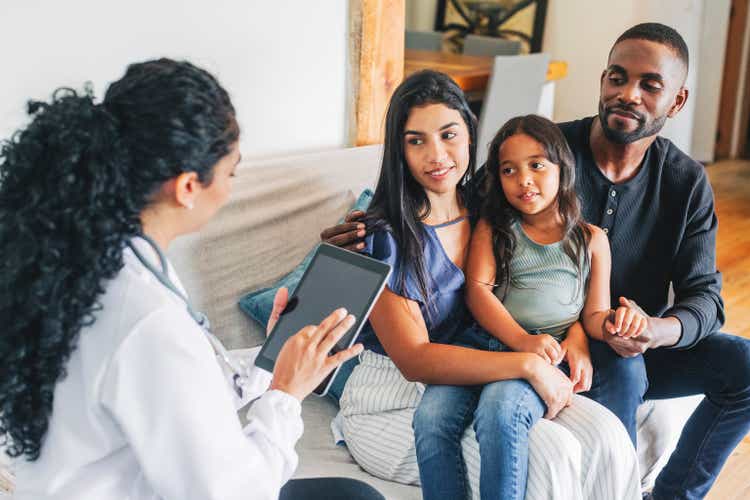 Young family getting medical consultation from doctor on house call