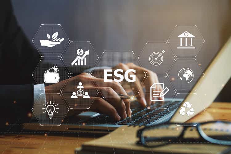 Businessman hand using a laptop with ESG icon on screen display, taking into account modern technologies and environmental safety. ESG environment social governance investment business concept.