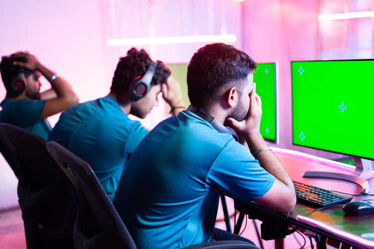 Professional gamer got disappointed due to match loss while playing vidoe game on Green screen Mock up monitor - concept of teamwork, esport championship tournament.