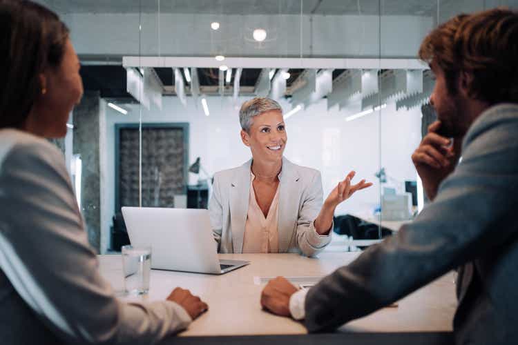 Group of business persons talking in the office.