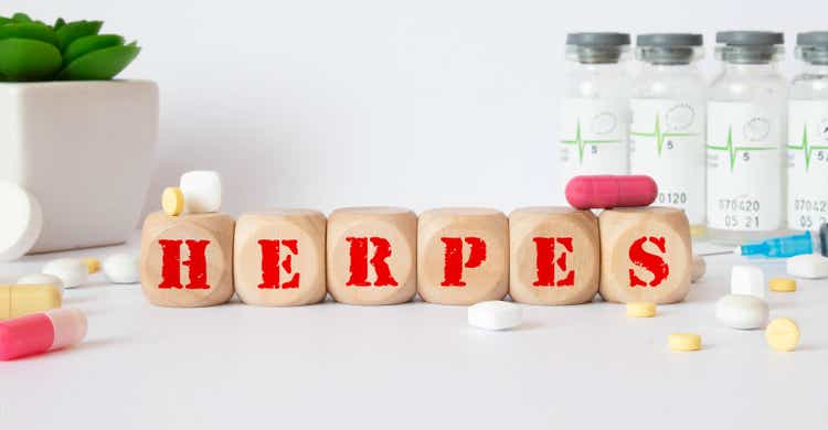 Herpes - word from wooden blocks with letters, viral diseases herpes viruses concept, blue background