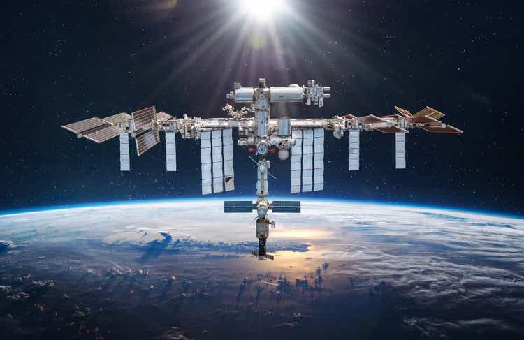 International space station in 2022 in outer space. ISS floating on orbit of Earth planet. Space sci-fi collage with satellite and spaceship. Astronauts on orbit. Elements of this image furnished by NASA