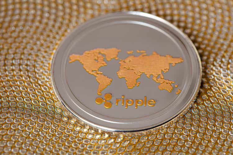 Ripple coin, XRP token, cryptocurrency on golden background