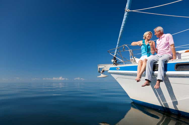 Happy Senior Couple on the Bow of a Sail Boat