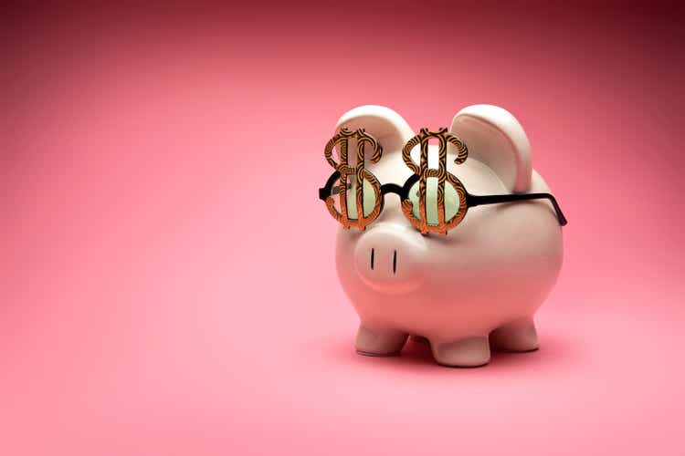 Concept image of a white large piggy bank on a pink background