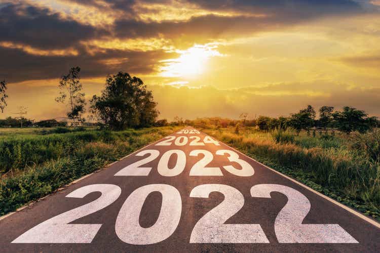 New Year 2022 Goals Concept : Empty asphalt road sunrise with text go to New year 2022