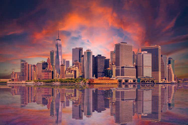 New York City Skyline with Manhattan Financial District, World Trade Center and Orange and Blue Sunset Sky.