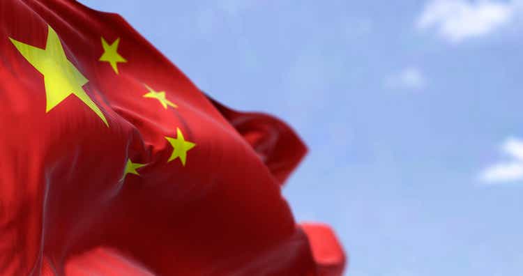Detailed close up of the national flag of China waving in the wind on a clear day