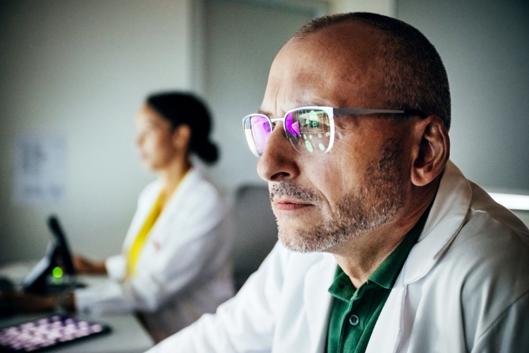 Doctor Concentrating On Computer Monitor