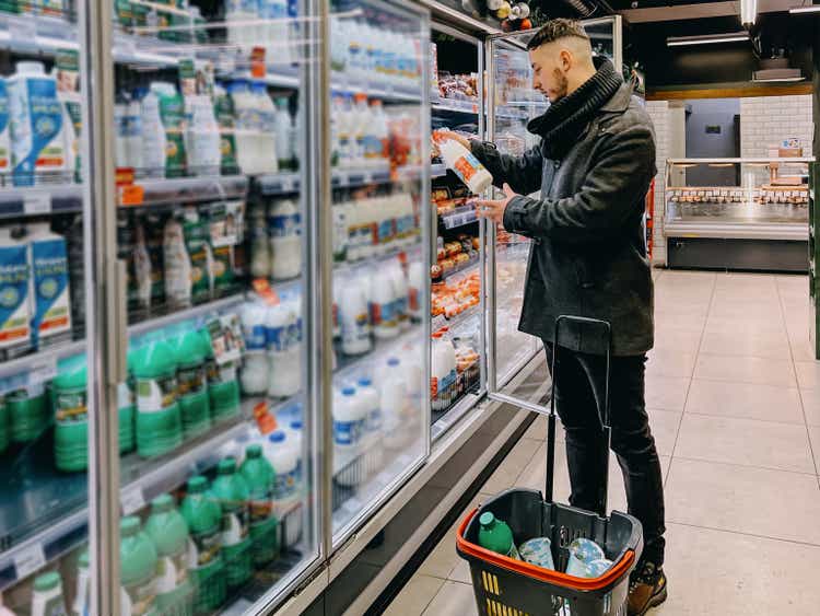 Guy Grocery Choosing Food In Super Market. Empty Space