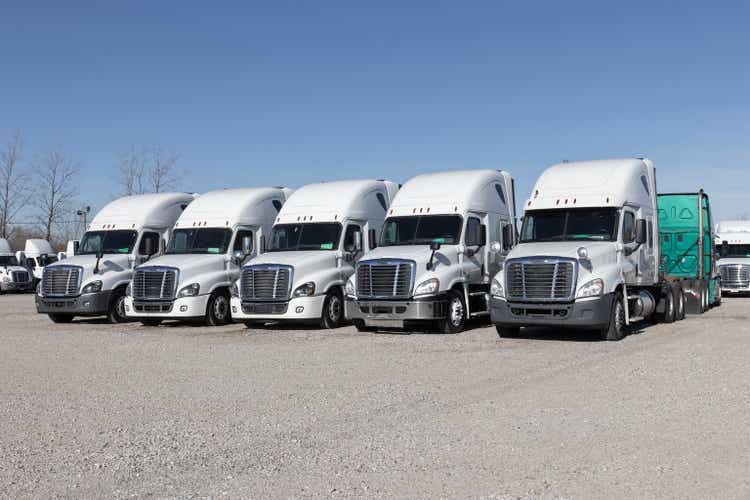 Freightliner Semi Tractor Trailer Trucks Lined up for sale. Freightliner is owned by Daimler.