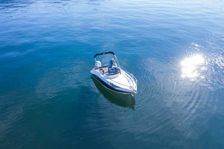 Drone aerial shot of man piloting a boat