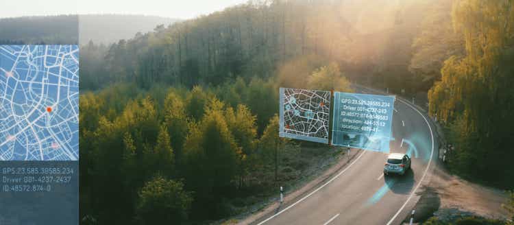 Autonomous Electric car driving on a forest highway with technology assistant tracking information, showing details. Visual effects clip - graphics are essential