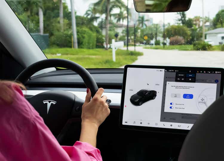 Cockpit with LCD touch screen of electric car Tesla Model Y during drive.