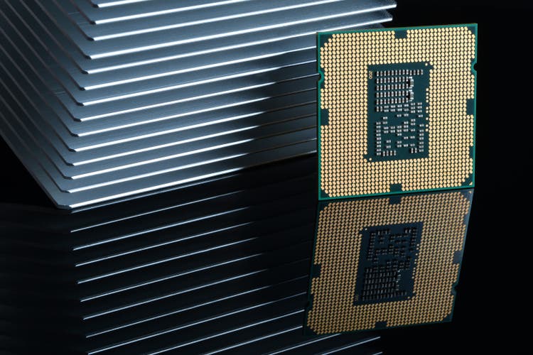Close up of Computer Processor with Aluminum Heatsink on Black Reflective Background