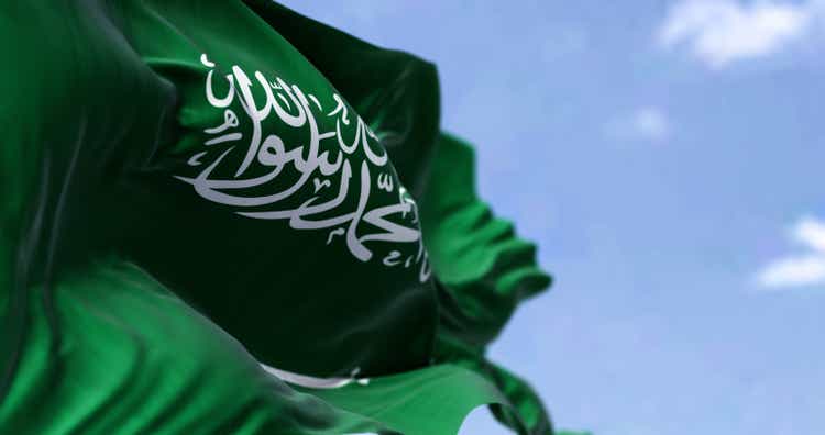 Detailed close-up of the national flag of Saudi Arabia fluttering in the wind on a clear day