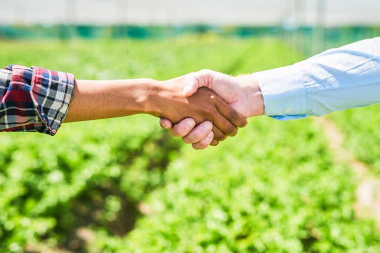 Closeup shot of an unrecognisable man and woman shaking hands on a farm