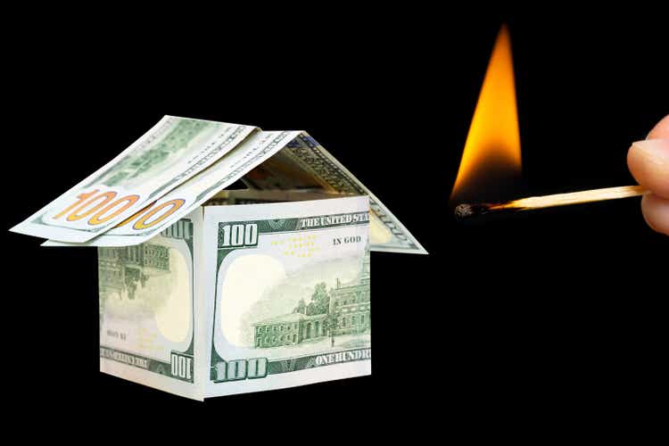 Matchstick setting fire to a dollar bills house