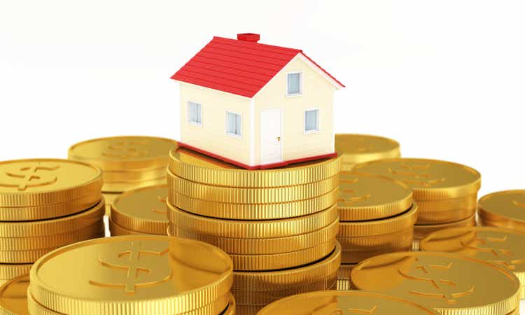 3d render Miniature House Sitting On Top Of Coin Stack: Real Estate and Savings Concept stock photo