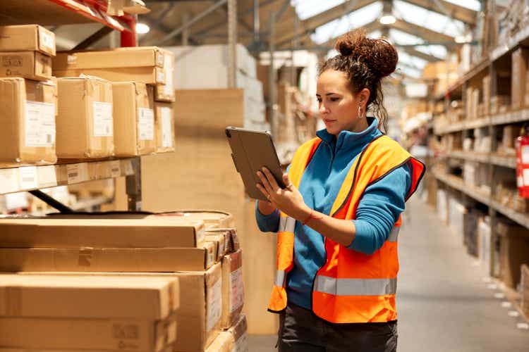 A warehouse worker takes inventory in the storage room.