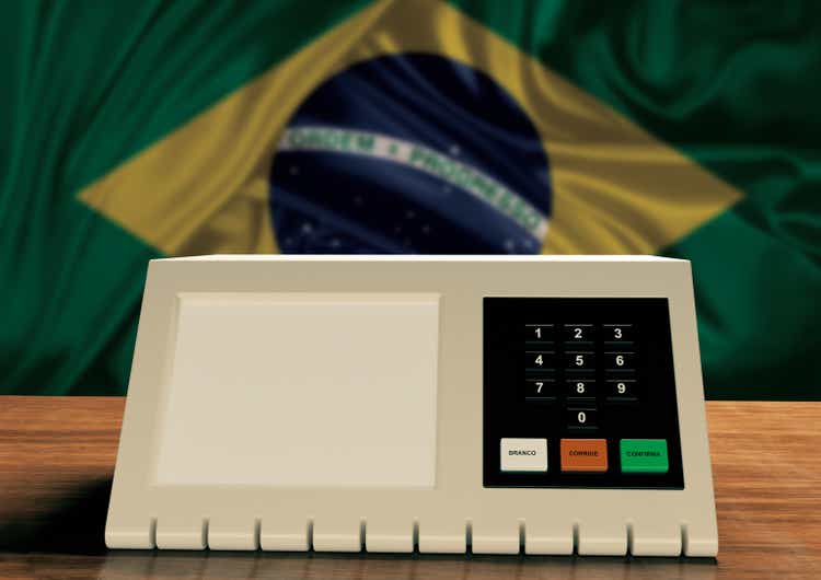 Electronic ballot box used in Brazil elections with Brazilian flag in the background